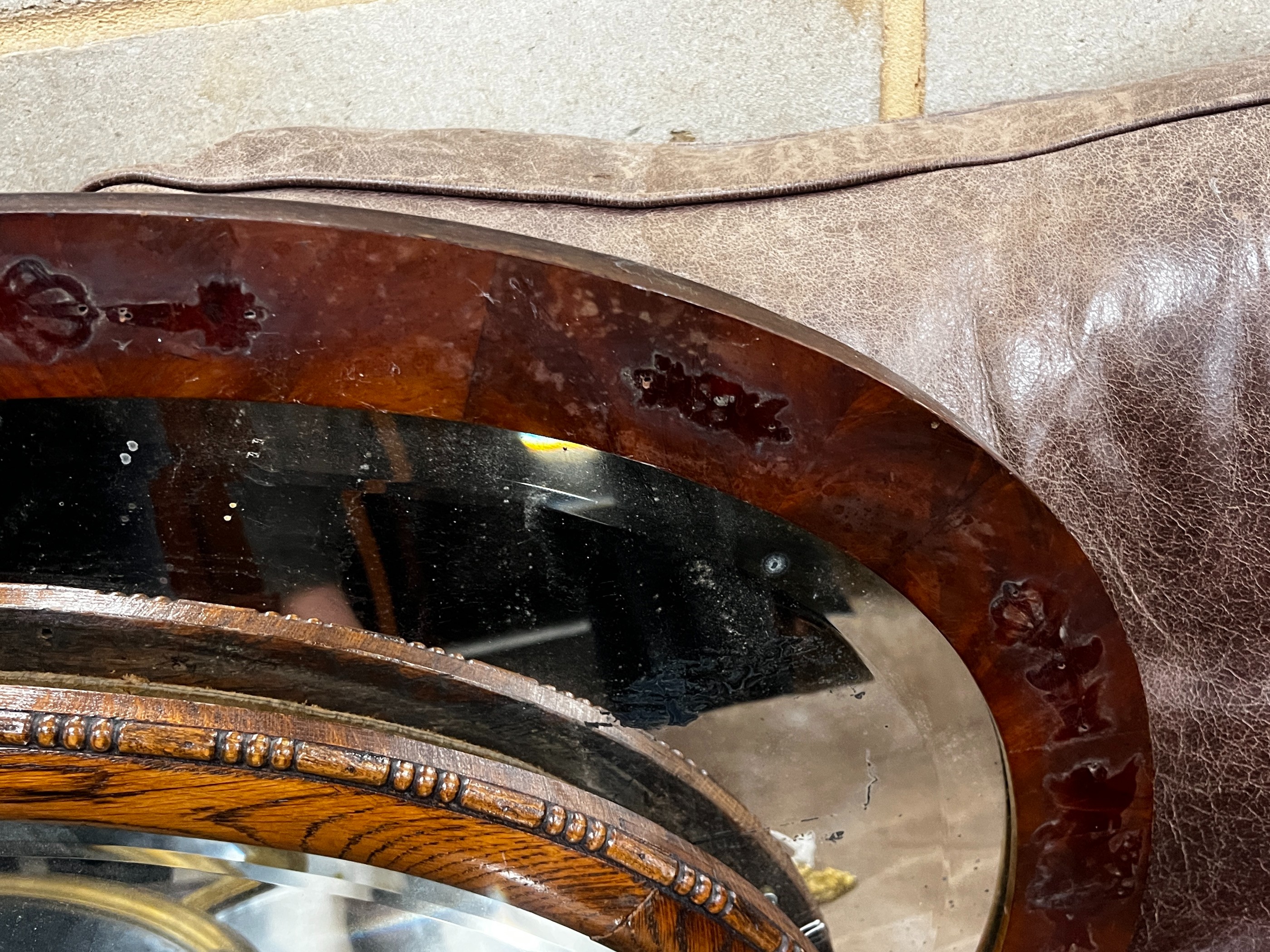Two early 20th century oval wall mirrors, larger width 86cm